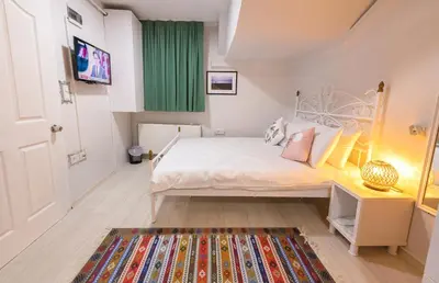 a small bedroom with a white bed and a rug at Duru Istanbul Apart in Istanbul