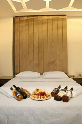 a bed with two plates of food and drinks on it at Blueway Hotel Istanbul Bakırköy City Center in Istanbul