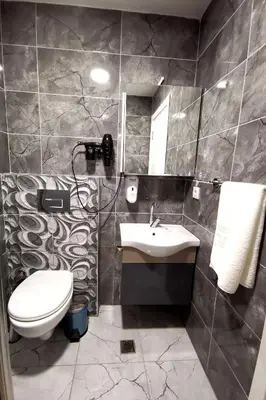 a bathroom with a sink and a toilet and a mirror at Blueway Hotel Istanbul Bakırköy City Center in Istanbul