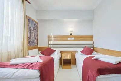 a hotel room with two beds with red and white sheets at Central Suites Taksim in Istanbul
