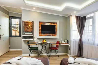 a living room with a table and chairs at Gloria Suites Old City in Istanbul