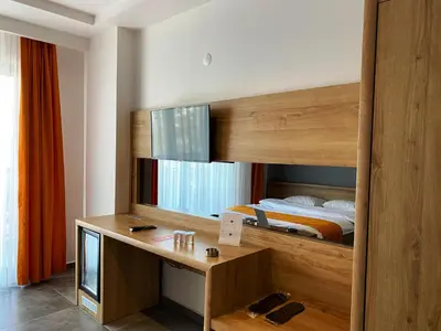 a bedroom with a bunk bed with a desk and a bed at MOPE Hotel in Tekirdag