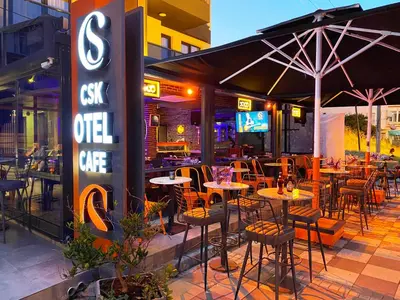 a restaurant with tables and chairs and a sign at MOPE Hotel in Tekirdag