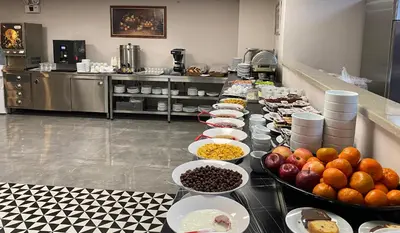 a buffet with bowls of food on a table at BUSINESS EXPRESS HOTEL in Tekirdag