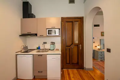 a small kitchen with a sink and a microwave at O'Pera Okanlı Suites in Istanbul