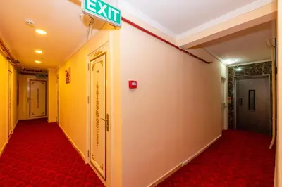 a hallway with a exit sign on the wall at Avrupa Palace Hotel in Avcılar