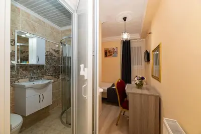 a bathroom with a shower and a toilet and a sink at Avrupa Palace Hotel in Avcılar