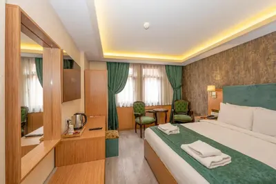 a hotel room with a bed and a desk at The Hotel Devman & Terrace in Istanbul