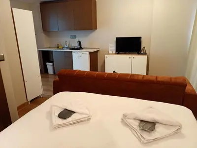 a room with a couch and a table with towels at Doğan Palas Suites in Istanbul