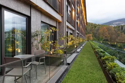 a balcony with tables and chairs and plants at NG Enjoy in Sapanca