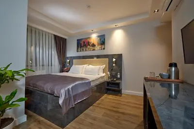 a hotel room with a bed and a television at The Bold Hotel in Istanbul