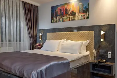 a hotel room with a bed and a painting on the wall at The Bold Hotel in Istanbul