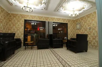 a waiting area with chairs and a table in a room at HOTEL ÜMİT YENİKAPI in Istanbul
