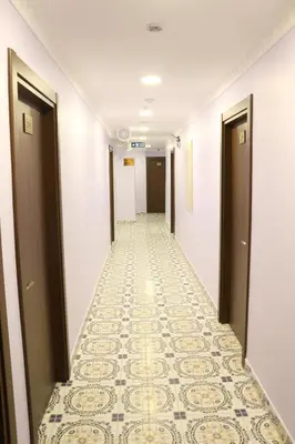 a corridor of a hotel with a tile floor at HOTEL ÜMİT YENİKAPI in Istanbul