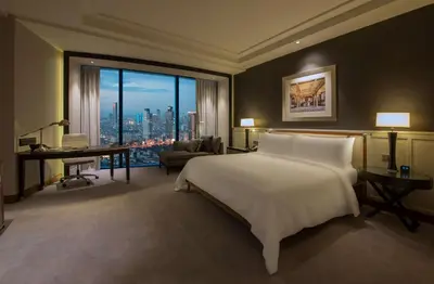 a bedroom with a large white bed and a desk at Hilton Istanbul Bomonti in Istanbul
