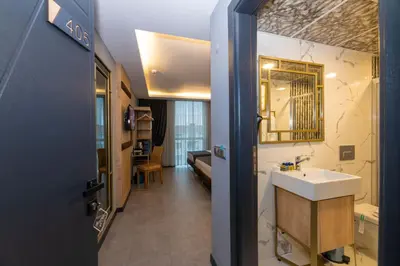 a bathroom with a sink and a mirror at Fly And Stay Airport Hotel in Istanbul