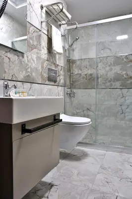 a bathroom with a sink and a shower at Fly And Stay Airport Hotel in Istanbul