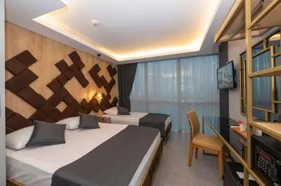 a hotel room with two beds and a television at Fly And Stay Airport Hotel in Istanbul