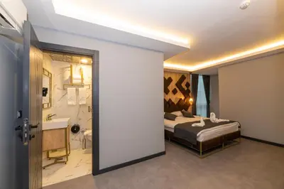 a hotel room with a bed and a bathroom at Fly And Stay Airport Hotel in Istanbul