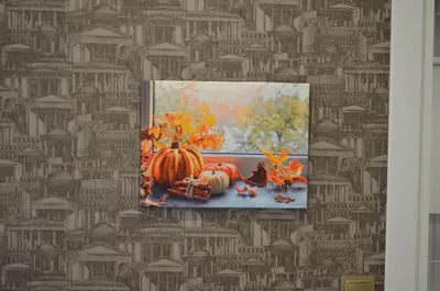 a painting on a wall with pumpkins and autumn leaves at Rodion Hotel in Istanbul