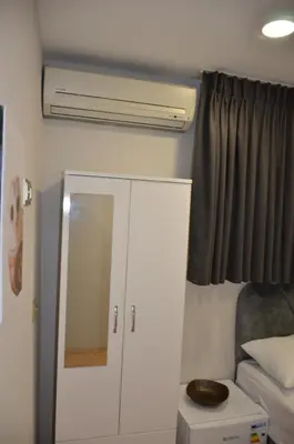 a bedroom with a white cabinet and a mirror at Rodion Hotel in Istanbul