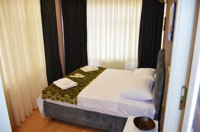 a bedroom with a bed with two towels on it at Rodion Hotel in Istanbul