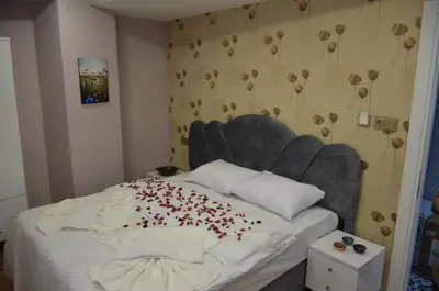 a bed with a bunch of red hearts on it at Rodion Hotel in Istanbul