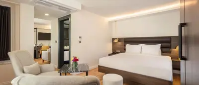 a bedroom with a bed and a living room at The Rooms Nisantasi in Istanbul
