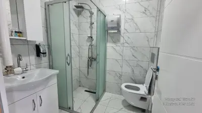 a bathroom with a shower and a toilet and a sink at VESTA RESORT BUTİK HOTEL in Istanbul