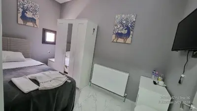 a small bedroom with a bed and a mirror at VESTA RESORT BUTİK HOTEL in Istanbul