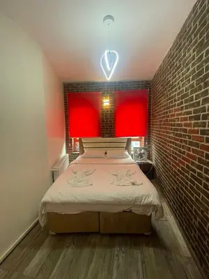 a bedroom with a bed and a brick wall at GRAND BELLA VİSTA Hostel in Istanbul