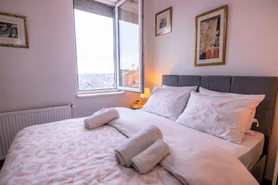 a bedroom with a large white bed with two pillows at Taksim Roya Apartment -center of the Istanbul in Istanbul
