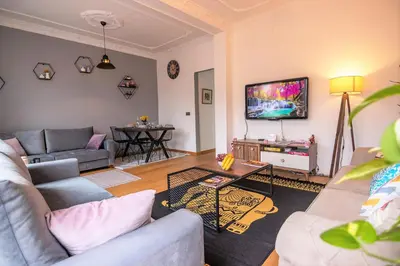 a living room with a couch and a tv at Taksim Roya Apartment -center of the Istanbul in Istanbul