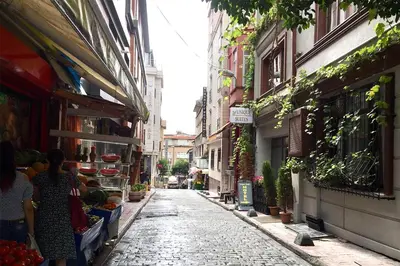 an alley with people walking down a street at Taksim Roya Apartment -center of the Istanbul in Istanbul