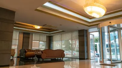 a lobby with chairs and windows and a chandelier at MOX Hotel Wellness & Spa in Sapanca
