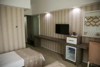 a hotel room with a bed and a flat screen tv at MOX Hotel Wellness & Spa in Sapanca