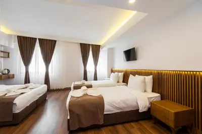 a hotel room with two beds and a television at Castillo Rojo Hotel Istanbul in Istanbul