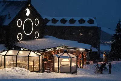 a building with lights in the snow at night at Oksijen Zone Hotel & Spa - Full Board Plus in Uludag