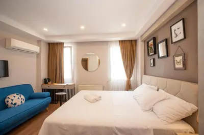 a bedroom with a bed and a blue couch at Taksim suıte in Istanbul