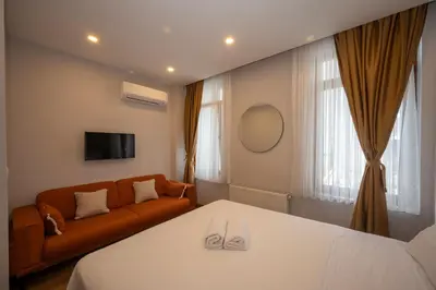 a hotel room with a bed and a couch at Taksim suıte in Istanbul