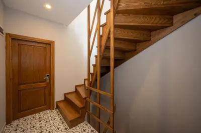 a wooden staircase in a room with a door at Taksim suıte in Istanbul