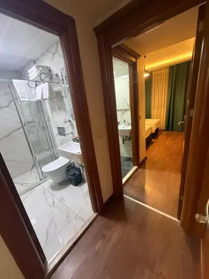 a bathroom with a sink and a toilet and a mirror at Pege Hotel in Istanbul