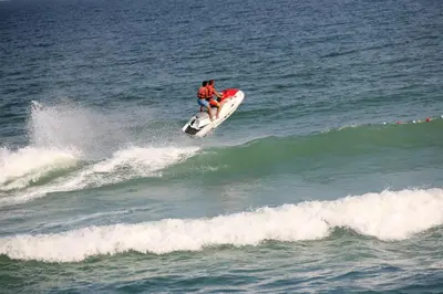 a man riding a wave on a surfboard in the ocean at İğneada Resort Hotel & SPA in Igneada