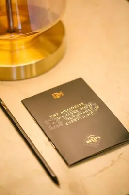 a book sitting on a table next to a pen at Delita City Hotel in Istanbul