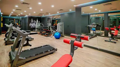 a gym with treadmills and machines in a room at Cabir Deluxe Hotel Sapanca in Sapanca