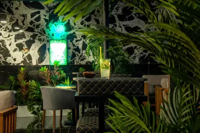 a room with plants and a table and a window at Hotel Bossuite Business in Istanbul