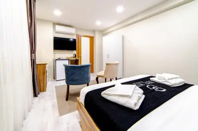 a bedroom with a bed with two towels on it at Best Hotel Pendik in Istanbul