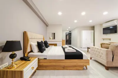 a bedroom with a large bed and a chair at Best Hotel Pendik in Istanbul