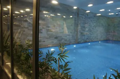 a large swimming pool inside of a building at Sakarya Hotel in Sakarya