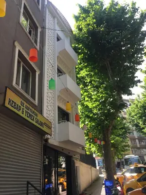 a building on a street with a tree next to it at Valeria House in Istanbul